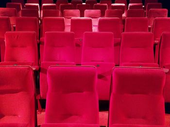 Full frame shot of red empty seats in auditorium