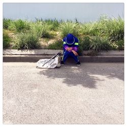 Rear view of woman sitting on beach