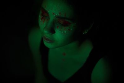 Woman sitting in a darkroom