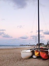 Boats moored on beach against sky