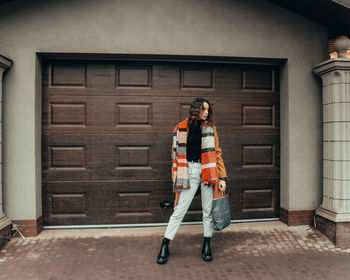 Full length of men standing outside house