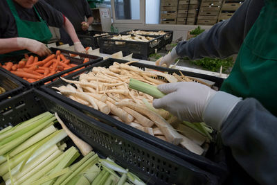 Midsection of people having food at market