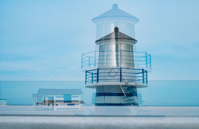 Reflection of lighthouse and beach hut