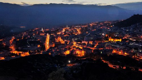 High angle view of illuminated buildings in city at night