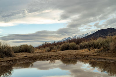 Scenic view of lake and mountains against sky