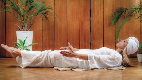 Woman practicing kundalini yoga, kriya exercises for the navel center and bowel waste elimination