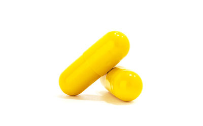 Close-up of yellow eggs against white background