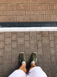 Low section of man standing on footpath