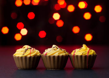 Close-up of cupcake against illuminated background