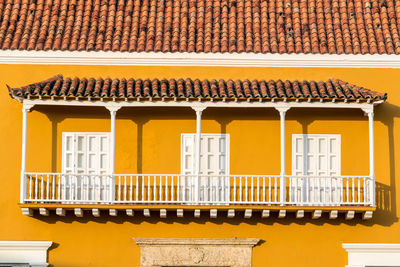 Exterior of yellow house during sunny day