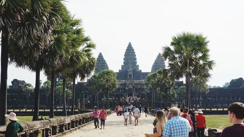 People at temple against sky