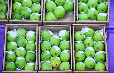 Green fruits for sale in market