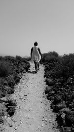 Full length of woman standing on railing