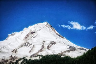 Scenic view of snowcapped mountain against blue sky