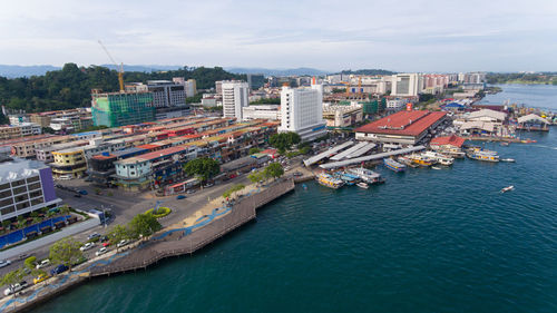 High angle view of buildings by sea against sky