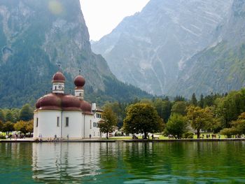 View of lake and trees against mountain range