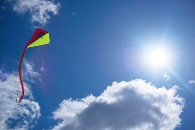 Low angle view of kite in mid-air against sky