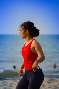 Side view of young woman at sea shore