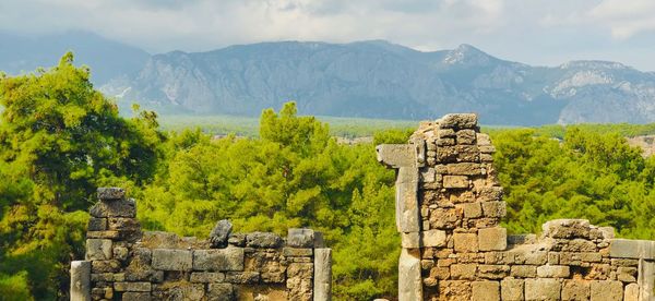 Stone wall against mountain range and sky