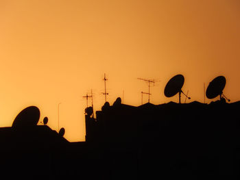 Low angle view of silhouette trees against sky at sunset