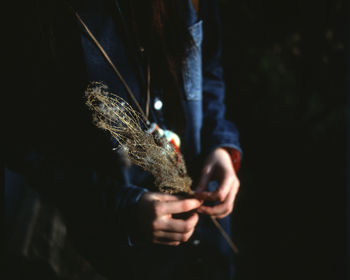 Close-up of hand holding cigarette