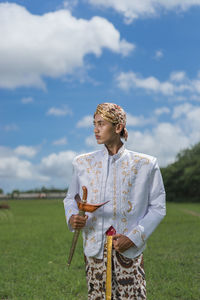Man in traditional clothes standing on field 