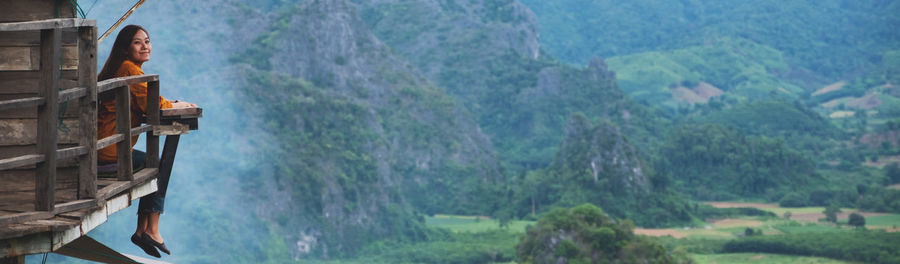 Man looking at view of waterfall