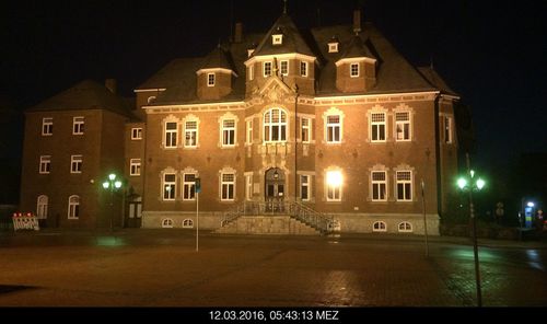 Illuminated building against sky at night