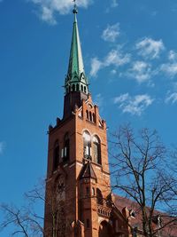 Low angle view of bell tower against blue sky