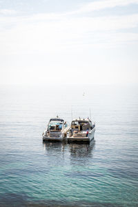 Boat sailing in sea against sky