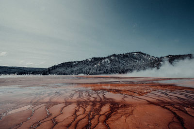 Scenic view of lake against cloudy sky during winter