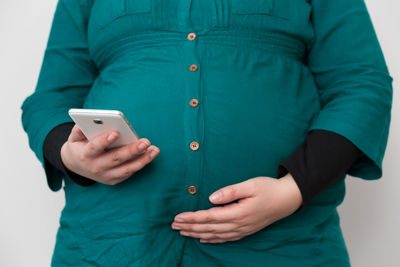 Midsection of man using mobile phone