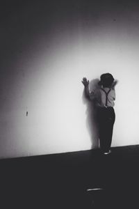 Man holding umbrella standing on floor