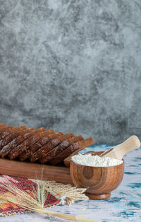 Close-up of bread in bowl against white background