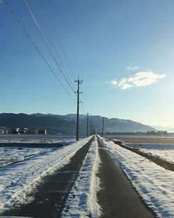 Road by mountain against sky