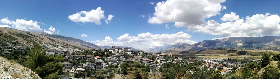 Panoramic view of houses and mountains against sky