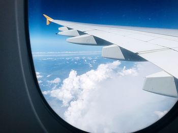 Aerial view of clouds seen through airplane window