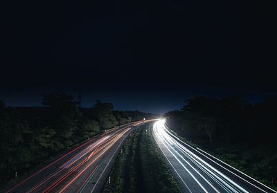 High angle view of light trails on highway at night