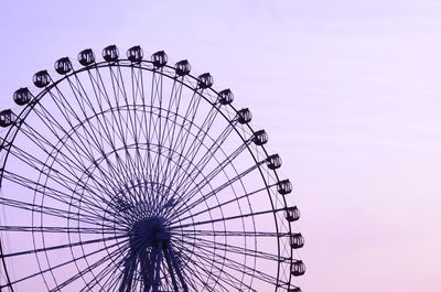 Low angle view of ferris wheel against clear sky