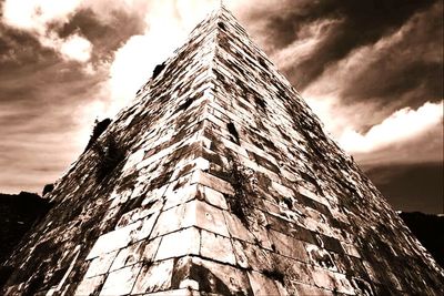 Low angle view of building against cloudy sky