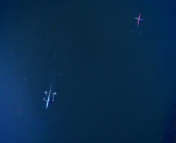 High angle view of boats on sea at night