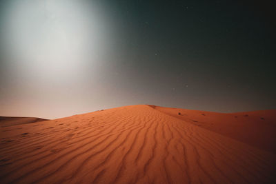Scenic view of desert against night sky
