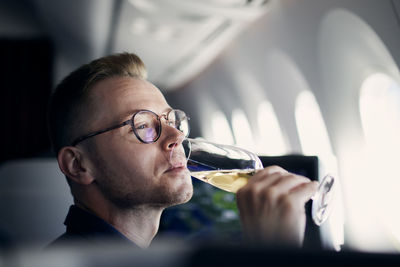 Portrait of man drinking glasses