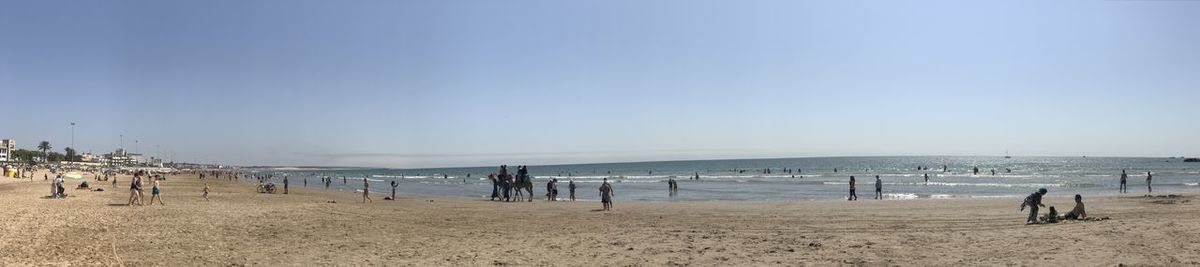 People on beach against sky