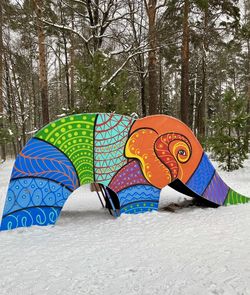 Multi colored umbrella against trees in forest