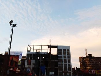 Low angle view of building at construction site against sky