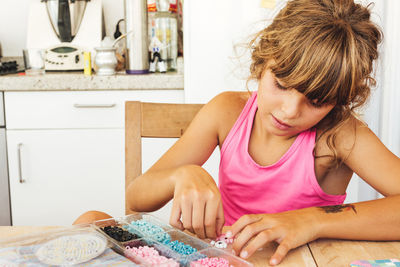 Girl sitting on table at home