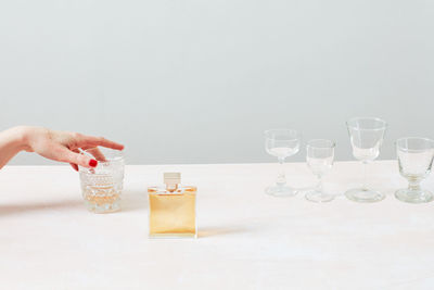 Red nails, perfume, whiskey, glasses