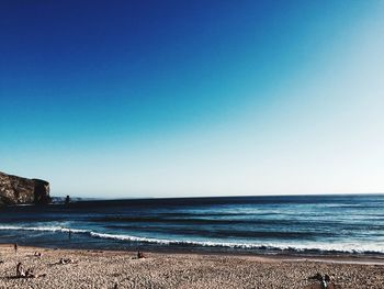 Scenic view of sea against clear blue sky