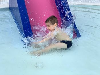 Full length of boy splashing water